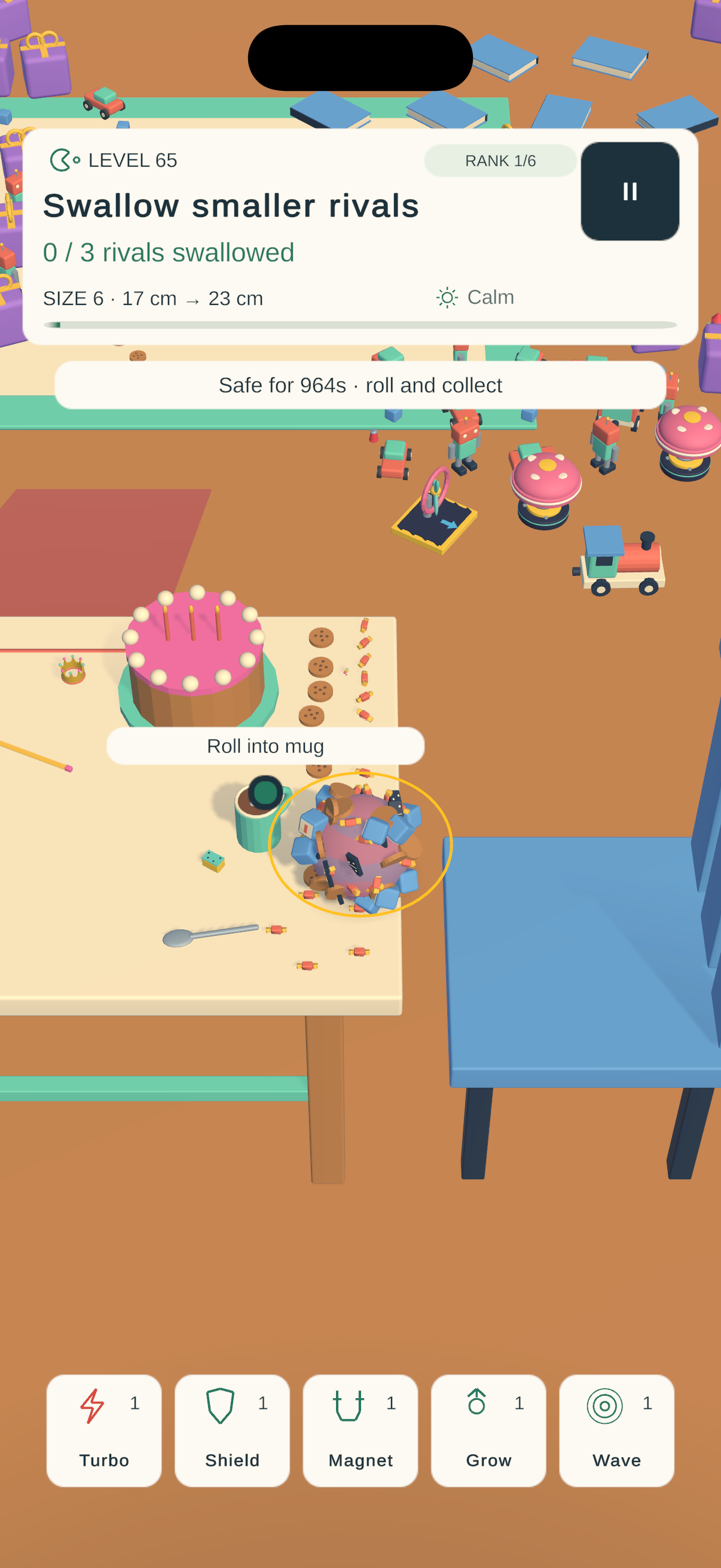 A grown Stickyboop ball covered in collected objects beside a birthday cake